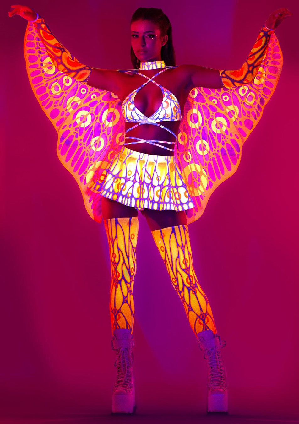 a girl wearing glow-in-the-dark neon clothing with wings