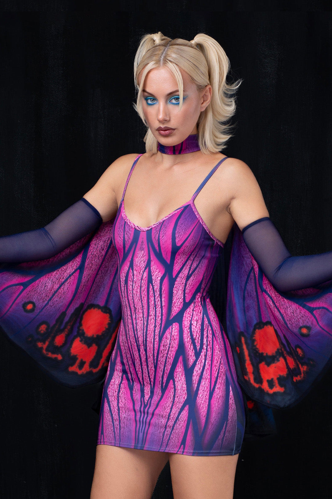 a Halloween party look with a purple winged dress