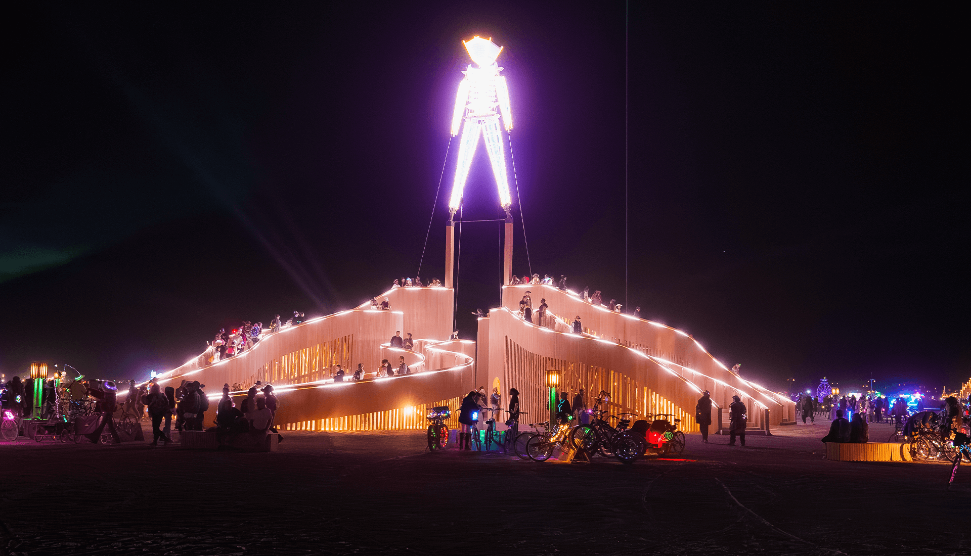The Burning Man effigy on an elevated platform with illuminated pathways