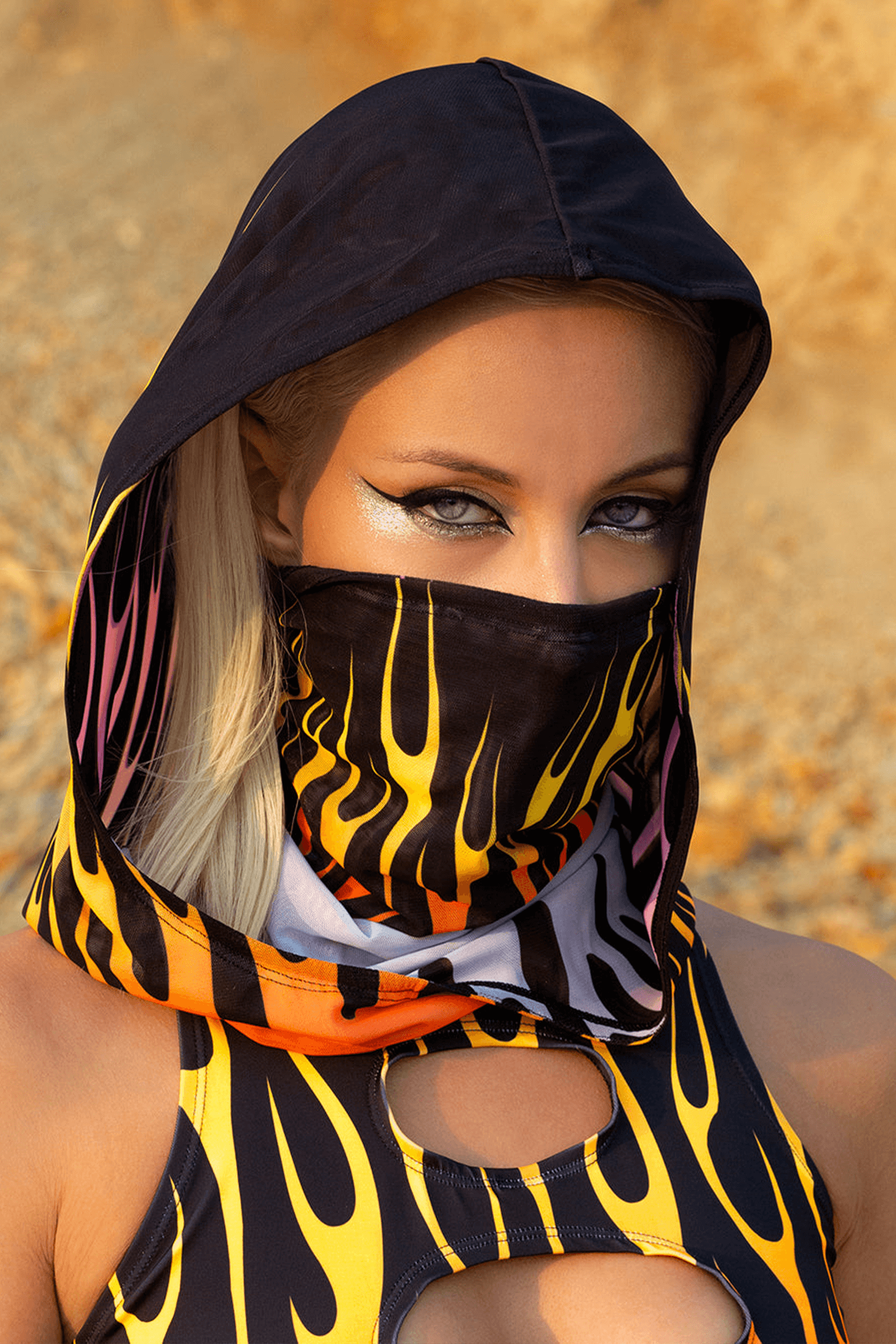 Person at EDM event wearing a face mask and hood