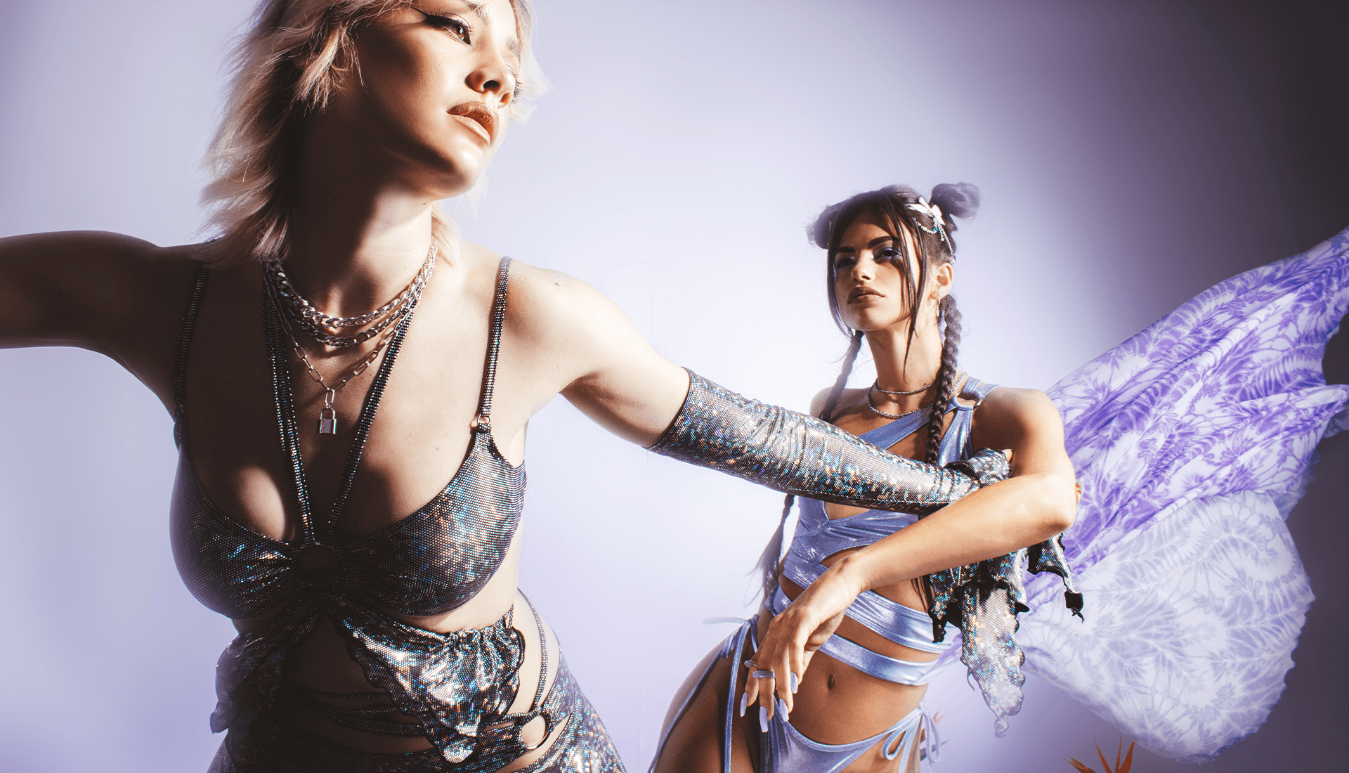 women wearing fairy clothing in reflective metallics and light purple