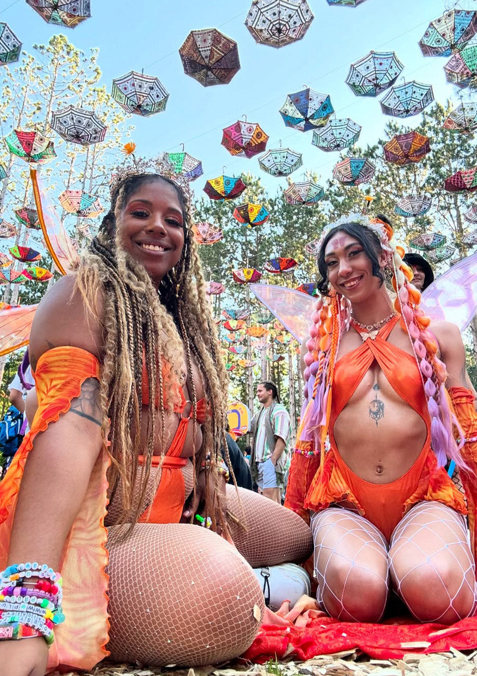 women in matching festival outfits enjoying the immersive experience of Electric Forest