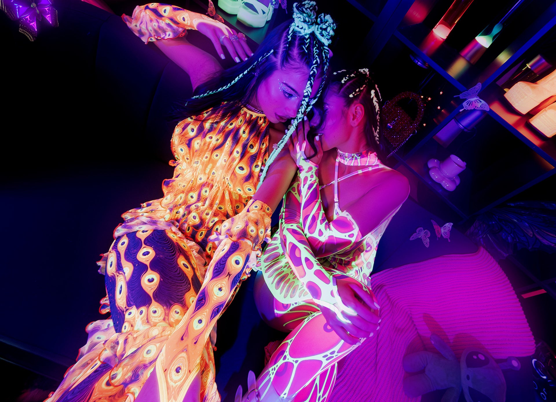 two girls wearing neon uv-rective outfits for a rave