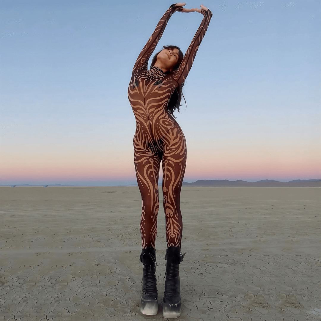 Woman in Burning Man themed bodysuit in desert