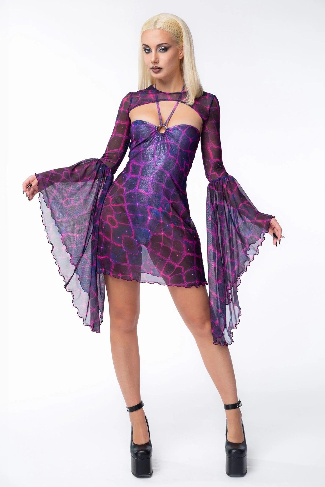 sexy witch Halloween character dressed in layered purple bodysuit and mesh dress