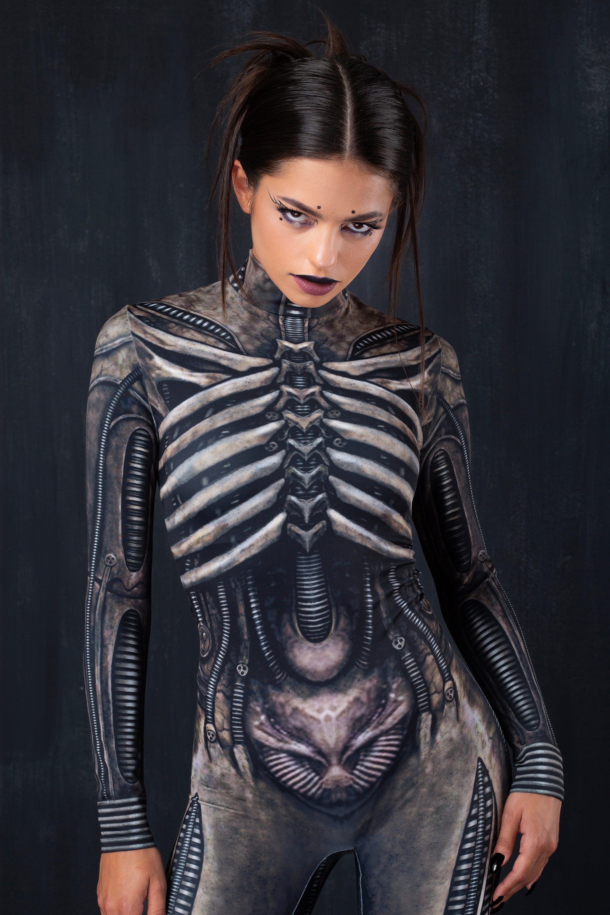 BADINKA bodycon women's Halloween costume with UV-reactive alien-inspired graphics and long sleeves; close-up front view