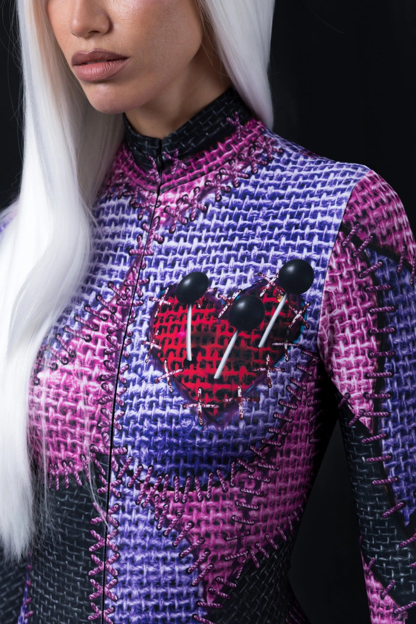 close up of a voodoo doll costume with needles through the heart