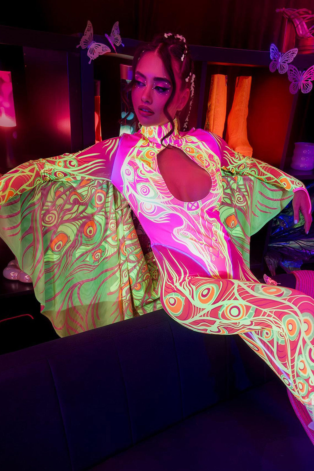 woman wearing a winged catsuit at an indoor rave party