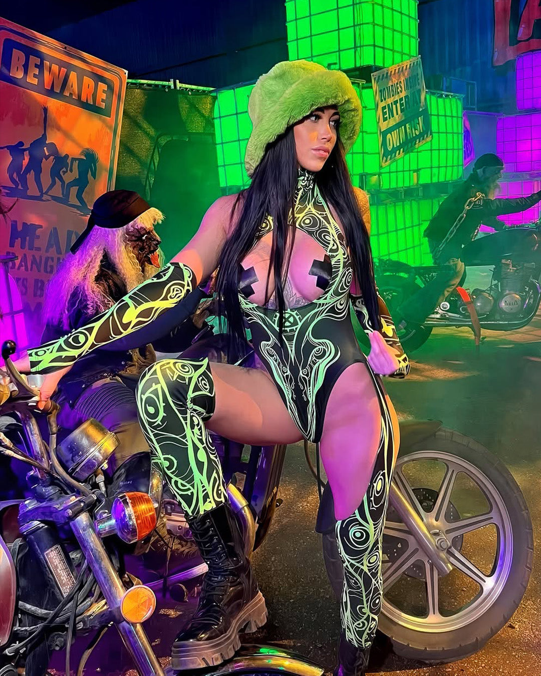 woman in a green cut-out catsuit at a mesic festival