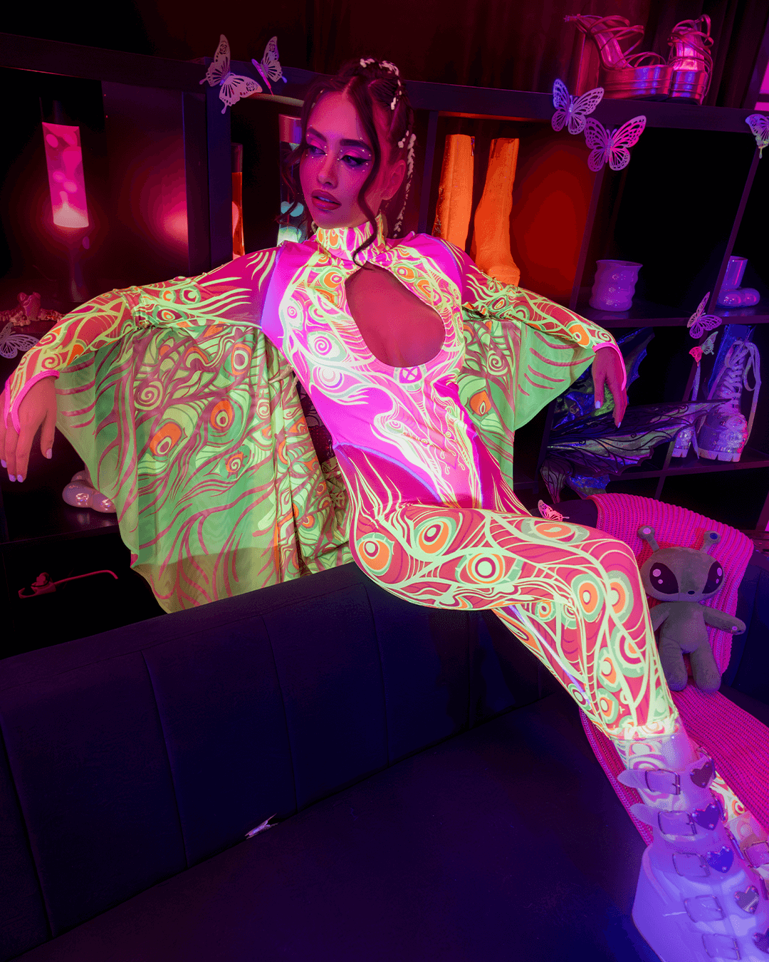 woman on a party wearing glowing keyhole winged catsuit