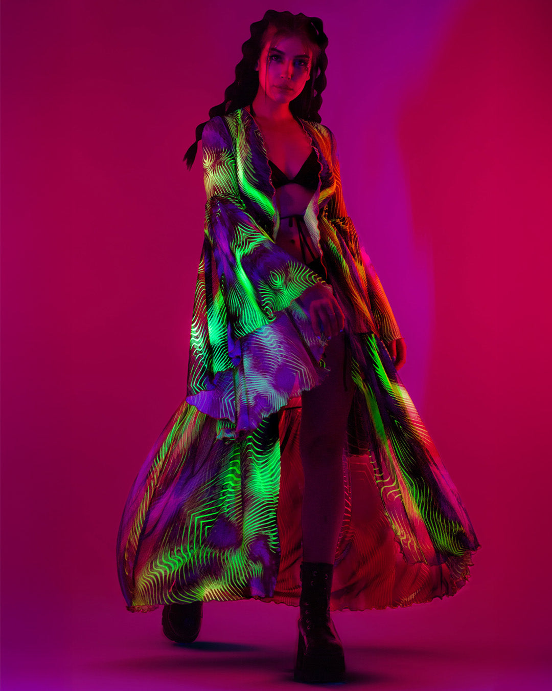 woman wearing an unisex mesh duster that glows in the dark for Electric forest music festival