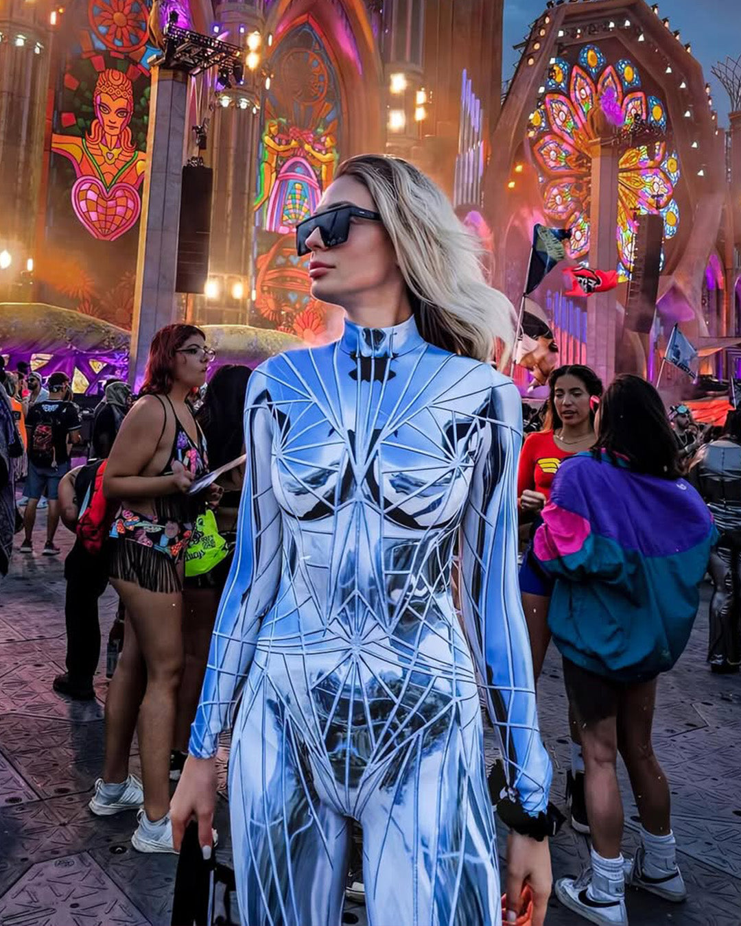 woman wearing a BADINKA festival full-body costume with broken mirror print