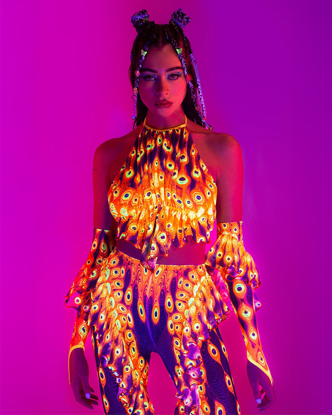 woman wearing an orange neon UV-reactive set for Electric Forest