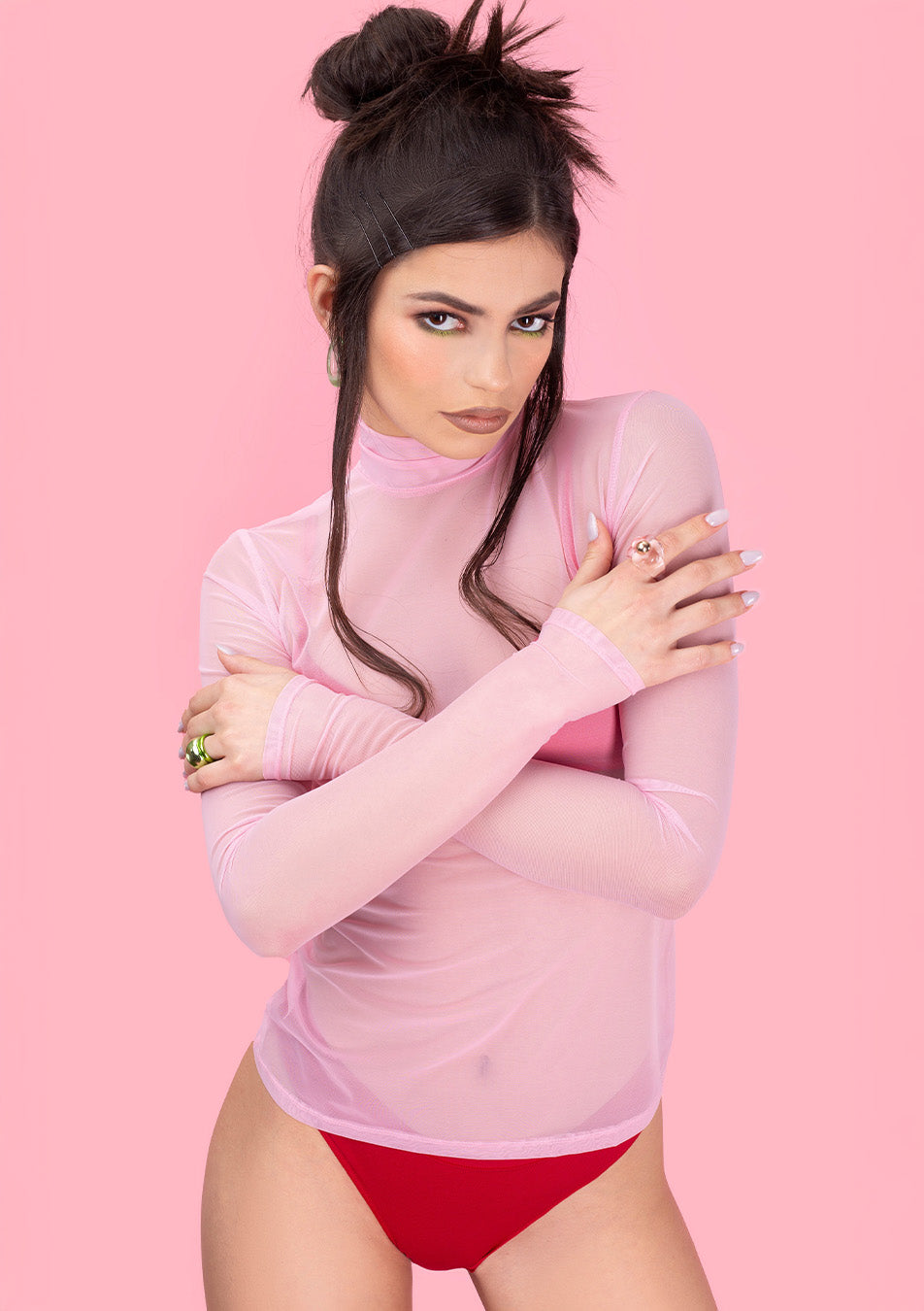 person wearing a mesh long-sleeve shirt in baby pink