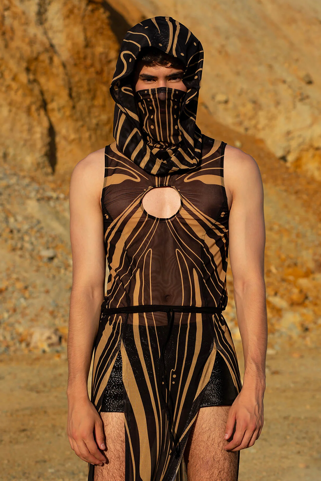 A man in the desert wearing a hooded sand warrior tunic